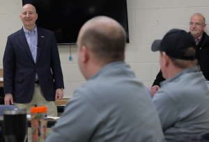 Photo of Gov. Ricketts speaking with corrections workers.
